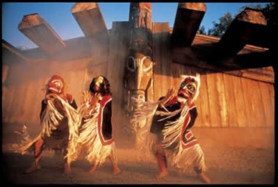 First Nations Dancers infront of Longhouse
