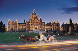 Parliament Buildings in Victoria at Night with Horse Carriage infront